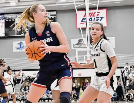  ?? Mark Stockwell/Associated Press ?? UConn’s Dorka Juhasz, left, grabs a rebound as Providence’s Kylee Sheppard (1) watches on Wednesday.