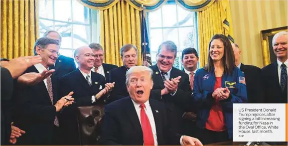  ?? AFP ?? US President Donald Trump rejoices after signing a bill increasing funding for Nasa in the Oval Office, White House, last month.