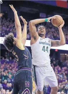  ?? NAM Y. HUH/ASSOCIATED PRESS ?? Michigan State forward Nick Ward, right, goes up for a shot against Northweste­rn center Barret Benson on Saturday in Rosemont, Ill.