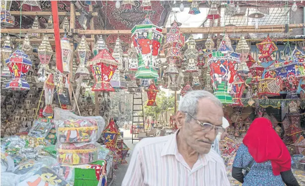  ??  ?? Left Ramadan lanterns, some with the image of Liverpool striker Mohamed Salah, hang at a street stall in Cairo.