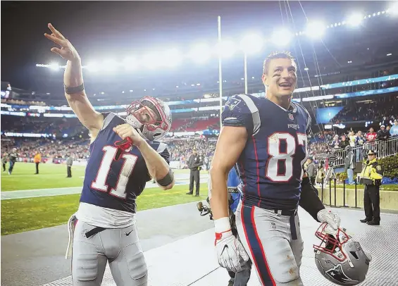  ?? STAFF PHOTO BY NANCY LANE ?? DEEP THOUGHTS: Julian Edelman (left) and Rob Gronkowski walk off the Gillette Stadium field following Sunday’s win against Kansas City. Gronkowski was added to the Patriots injury report yesterday with an ankle issue.