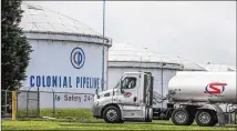  ?? JOHN SPINK/JOHN.SPINK@AJC.COM ?? A tanker truck passes Colonial Pipeline storage tanks Monday in Austell before entering the Marathon Powder Springs Terminal. A ransomware attack shut down the Alpharetta-based firm’s pipeline delivering some 45% of fuel consumed on the East Coast.