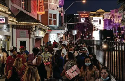  ?? New York Times file photo ?? A trio of scientists proposes a “fringe” idea of escalating herd immunity to COVID-19 by having young people continue life as normal, like this crowd on the Las Vegas Strip on July 31. The White House says the idea reinforces the president’s strategy.