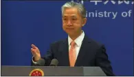  ?? (AP/Liu Zheng) ?? Chinese Foreign Ministry spokespers­on Wang Wenbin reacts during the daily presser at the Ministry of Foreign Affiairs Friday in Beijing.