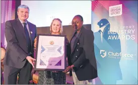  ?? (Photo: Stephen McCarthy/ Sportsfile) ?? Niamh Daffy, CEO Cara Sport Inclusion Ireland, presenting Graham Clifford, founder and CEO of The Sanctuary Runners, and Chawa Ndlovu with the Best Initiative to Promote Inclusivit­y in Sport and Physical Activity award during the Irish Sport Industry Awards 2022 in Dublin last week.