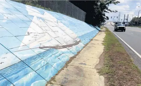  ?? KEVIN MCGILL/AP ?? A mural along Africatown Boulevard in Mobile, Alabama, depicts Clotilda, the last ship that brought slaves to the U.S.