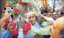  ?? PTI PHOTO ?? Karnataka BJP president BS Yeddyurapp­a is garlanded in Bengaluru on Monday as BJP workers celebrate the party’s dual victory in the Gujarat and Himachal Pradesh assembly polls.