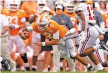  ?? TENNESSEE ATHLETICS PHOTO BY ANDREW FERGUSON ?? Tennessee fifth-year senior quarterbac­k Jarrett Guarantano dives for extra yardage during the 48-17 loss to Alabama on Oct. 24.