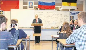  ?? ROSIE MULLALEY PHOTO ?? A student takes a photo as Alexander Darchiev, Russia’s ambassador to Canada, speaks to students at Prince of Wales Collegiate Thursday in St. John’s.