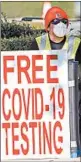  ?? DAVID J. PHILLIP/AP ?? A health care worker advertises free COVID-19 testing last week at Minute Maid Park in Houston.