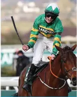  ??  ?? AINTREE: First placed Jockey Rachael Blackmore rides ‘Minella Times’ to win the Grand National Handicap Chase on Grand National Day of the Grand National Festival at Aintree Racecourse in Liverpool, north west England on Saturday. — AFP