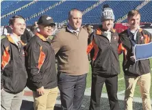 ?? HERALD PHOTO BY GREG DUDEK ?? EARLY LOOK: Middleboro coach Pat Kingman poses with his captains yesterday at Gillette Stadium, where the Sachems will face Littleton in Saturday’s Division 6 Super Bowl.
