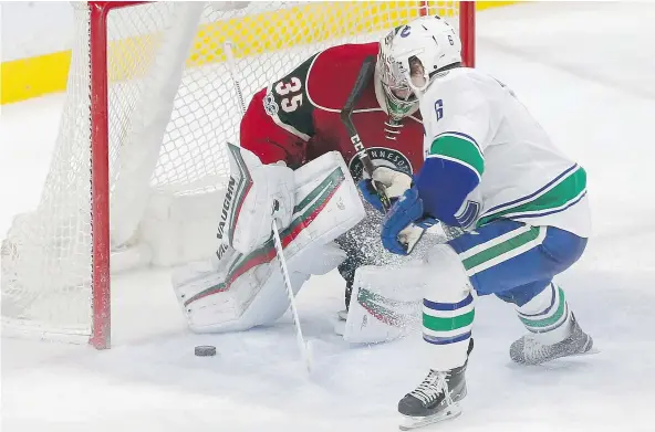  ?? — PHOTOS: THE ASSOCIATED PRESS ?? Vancouver’s Brock Boeser, signed just Saturday morning, scores against Minnesota goalie Darcy Kuemper as he made his NHL debut during an afternoon game in St. Paul. Boeser played for the University of North Dakota the previous night.