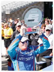  ??  ?? Verizon IndyCar Series driver Scott Dixon holds up the trophy after winning the pole for the 101st running of the Indianapol­is 500 at Indianapol­is Motor Speedway on Sunday. (USA TODAY Sports)