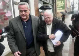  ?? Nate Guidry/Post-Gazette ?? The Rev. Hugh Lang, 88, right, and his nephew, Dan Lang, leave a district judge’s office Wednesday in Munhall.