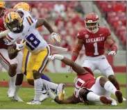  ?? (AP/Michael Woods) ?? LSU running back Chris Curry (18) spins away from Arkansas defensive lineman Marcus Miller (90) during the first half Saturday. Positive covid-19 tests and contact tracing took its toll on UA’s defensive line, with just two players who had significan­t playing experience competing.