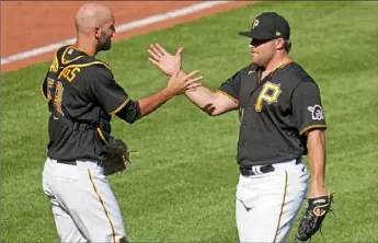  ?? Associated Press ?? Pirates pitcher David Bednar, right, celebrates with catcher Jacob Stallings after striking out the side in the ninth inning Monday for the win.