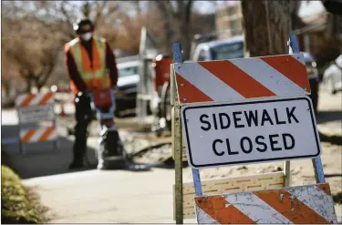  ?? HELEN H. RICHARDSON — DENVER POST FILE ?? A neighborho­od sidewalk repair crew works on a sidewalk repair in 2020 in Denver.