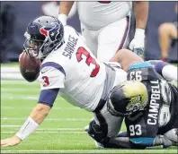  ?? AP PHOTO ?? Houston Texans quarterbac­k Tom Savage (left) is sacked by Jacksonvil­le Jaguars defensive tackle Calais Campbell during an NFL game Sunday in Houston.
