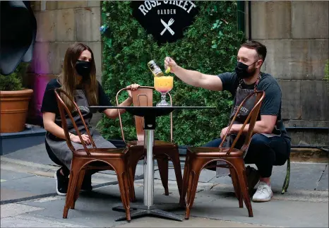  ?? Picture: Gordon Terris ?? Megan Grant and James King of the Rose Street Garden in Edinburgh rehearse making a cocktail ahead of next week’s reopening