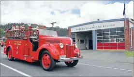  ??  ?? A vintage fire truck cruising outside the Stokes Valley Fire Station.