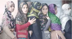  ?? — AFP ?? Women queue to cast their votes at a polling station in Muzaffarna­gar in Uttar Pradesh on Saturday.