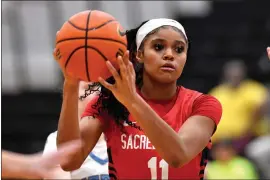  ?? TIMOTHY D. EASLEY — THE ASSOCIATED PRESS ?? Sacred Heart Academy guard ZaKiyah Johnson looks to pass during a high school basketball game against Mercy Academy in Louisville, Ky., Sunday, Feb. 11, 2024. Recruitmen­t letters have overwhelme­d one long shoe box, along with a backpack set aside for the frontrunne­rs. ZaKiyah Johnson will eventually get around to reading them, her mother believes, though it could be a while before the highly prized basketball recruit responds to those piquing her interest.