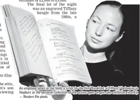  ??  ?? An employee poses as she holds a script for the film ‘Breakfast at Tiffany’s’ belonging to Hepburn as the personal collection of the actress goes on pre-sale exhibition recently. — Reuters file photo