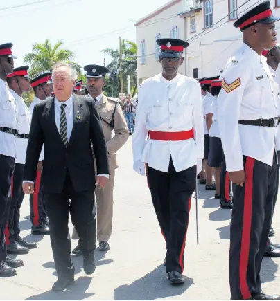  ?? PHOTO BY ADRIAN FRATER ?? Trelawny Custos Paul Muschett (in front) inspecting the guard of honour at the Independen­ce Day Civic Ceremony in Water Square, Falmouth, with Superinten­dent Kurt Ricketts.