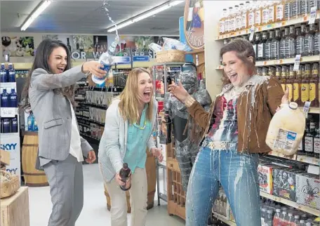  ?? Michele K. Short ?? CLEANUP in Aisle 3: Amy (Mila Kunis, left), Kiki (Kristen Bell) and Carla (Kathryn Hahn) let their inner wild girls out in “Bad Moms.”