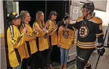  ?? MATT STONE / BOSTON HERALD ?? TEAMWORK: David Pastrnak greets members of the Boston Pride as he heads onto the ice before last night’s game at the Garden.