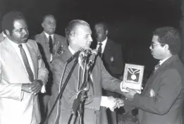  ?? ?? 1988: Prime Minister Edward Seaga (centre) presenting his Medal of Appreciati­on to Marlon Tucker, captain of the victorious Jamaican cricket team in the Red Stripe Cup Regional Cricket Competitio­n, at a reception at Jamaica House in March. Looking on at left is Edmund Bartlett, Minister of Youth and Community Developmen­t. At second left is Allan Rae, President of the West Indies Cricket Board of Control. THE GLEANER ARCHIVES