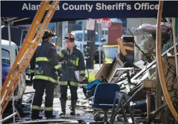  ?? ELIJAH NOUVELAGE/GETTY IMAGES/AFP ?? Firefighte­rs work at the scene of an overnight fire that claimed the lives of at least nine people at a warehouse in the Fruitvale neighbourh­ood of Oakland, California, on Saturday.