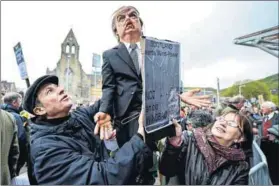  ?? Photo: Jeff J Mitchell/Getty Images ?? Then and now: Demonstrat­ors outside the Scottish Parliament in 2012 after Donald Trump spoke of his concerns over a proposed wind farm, mooted to be built near his new £1-billion golf resort, telling the Scottish Parliament that they would destroy...