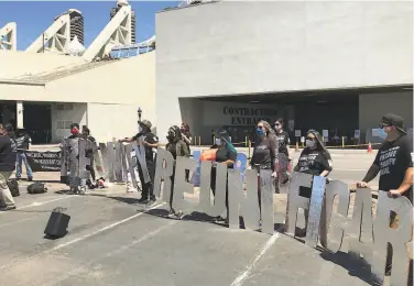  ?? Hillary Ronen ?? Activists gather outside the San Diego Convention Center, where 1,450 migrant children are being held in a federal shelter after being transferre­d from overflowin­g Texas border facilities.