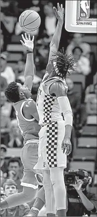  ?? AP/SCOTT THRELKELD ?? UCLA guard Aaron Holiday (left) shoots over Kentucky forward Wenyen Gabriel in the Bruins’ 83-75 victory over No. 7 Kentucky on Saturday. Holiday finished with 20 points and made a basket and two free throws in the last 33 seconds to seal the victory.