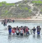  ?? VAL VERDE COUNTY SHERIFF JOE FRANK MARTINEZ ?? Migrants crossing the Rio Grande into Texas being rounded up by Val Verde County Sheriff deputies in April 2021.