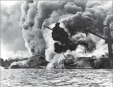  ??  ?? The USS Arizona was bombed at Pearl Harbor on Dec. 7, 1941. At left, men on the stern of USS Tennessee use fire hoses to force burning oil away from their ship. Nine hundred Arizona crewmen are entombed in the sunken ship.