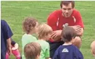  ?? FAMILY SUBMITTED PHOTO ?? Ches Linebarier talks to young soccer players when he was coaching HappyFeet .