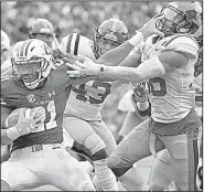  ?? AP/THOMAS GRANING ?? Auburn running back Kerryon Johnson (21) stiff-arms Mississipp­i defensive back Zedrick Woods during the No. 12 Tigers’ 44-23 victory over the Rebels on Saturday in Auburn, Ala. Johnson ran for a career-high 204 yards and three touchdowns in the victory.