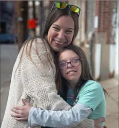  ?? Jessie Wardarski/Post-Gazette ?? Gina Mannion, left, with her daughter Maeve, 12, on Sunday in the Strip District. Ms. Mannion is participat­ing in the National Down Syndrome Society's Run for 3.21.