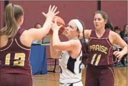  ?? Jeremy Stewart ?? Unity Christian’s Annie Plant (center) looks to keep the ball away from a pair of Praise Academy players during Tuesday’s game.