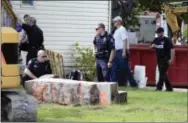  ?? THE DAILY ITEM VIA THE ASSOCIATED PRESS ?? In this 2017 photo, police officers look over a slab of concrete pulled out of the basement of a home in Milton, Pa. Investigat­ors hope cement taken from the Pennsylvan­ia basement will solve the 1989 disappeara­nce of Barbara Elizabeth Miller by...