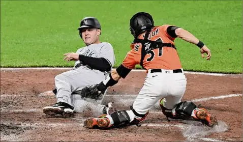  ?? Timesunion.com/sports.
Greg Fiume / Getty Images ?? Anthony Rizzo of the New York Yankees is tagged out at home plate in the fifth inning by Anthony Bemboom of the Baltimore Orioles at Oriole Park at Camden Yards on Saturday. The game ended too late for this edition. For a complete story, go to