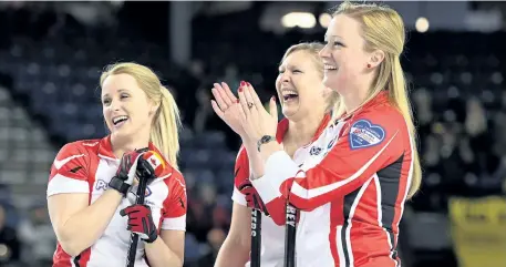  ?? SEAN KILPATRICK/THE CANADIAN PRESS ?? Canada skip Chelsea Carey, right to left, lead Laine Peters, and second Jocelyn Peterman laugh as second Amy Nixon (not pictured) dances with a mascot as they take on Northern Ontario in the bronze medal match of the Scotties Tournament of Hearts in...