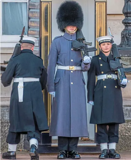  ??  ?? Big boots to fill: Able Seaman Alex Stacey, right, takes over from a soldier at Buckingham Palace