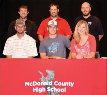  ?? RICK PECK/SPECIAL TO MCDONALD COUNTY PRESS ?? Ty Shaver (seated, center) recently signed a letter of intent to play baseball at Oklahoma Wesleyan University in Bartlesvil­le, Okla. Front row right to left: James Shaver (dad), Ty Shaver and Christina Shaver (mom). Back row: MCHS baseball coaches...