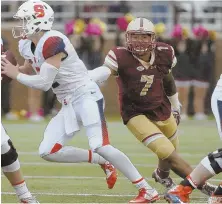  ?? STAFF PHOTO BY NANCY LANE (RIGHT); AP FILE PHOTO (ABOVE) ?? REACHING OUT: Harold Landry, shown trying to tackle Syracuse’s Eric Dungey during a game last season, once again leads the Boston College defense heading into Friday’s season opener vs. Northern Illinois.