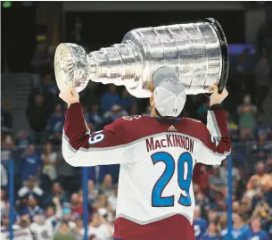  ?? PETERSEN/GETTY CHRISTIAN ?? Nathan MacKinnon hoists the Stanley Cup after the Avalanche’s title-clinching victory Sunday.