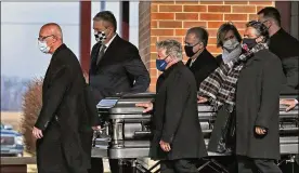  ?? KELLY WILKINSON / THE INDIANAPOL­IS STAR ?? Pall bearers, including Mario Andretti (center), walk the casket out after the Celebratio­n of Life service for Mario’s twin brother, Aldo Andretti, Jan. 13 at St. Malachy Catholic Church in Brownsburg, Ind.